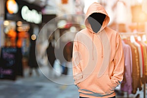 Peach hoodie with shop on background