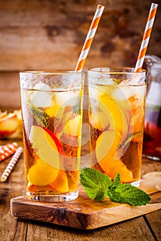 Peach ice tea in a glass with mint