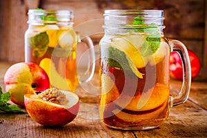 Peach ice tea in mason jar with mint