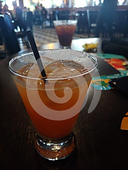 Peach margarita flavored drink in a glass.