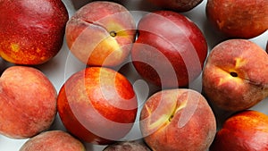 Peach and nectarine fruits close-up, top view. Rotation