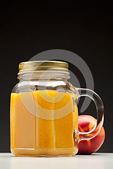 Peach or nectarine juice in closed jar