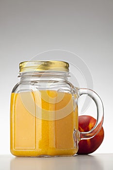 Peach or nectarine juice in closed jar