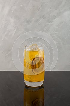Peach and passion fruit cocktail with soda water. Refreshing summer drink