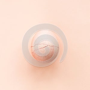 Peach pastel colored egg with ckrack.