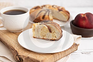 peach pie on a wooden table on a board and tea.The concept of breakfast.