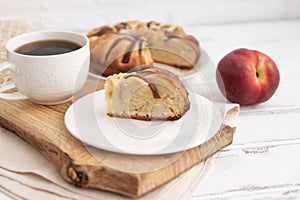 peach pie on a wooden table on a board and tea.The concept of breakfast.