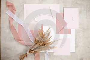 Peach pink pastel mock up composition of paper envelopes, seal wax, ribbons, hand craft jobbing. Weeding invitation. Top