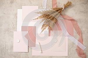 Peach pink pastel mock up composition of paper envelopes, seal wax, ribbons, hand craft. Valentine postcards. Flat lay