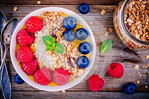 Peach smoothie bowl with raspberries, blueberries, granola and coconut