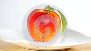 Peach on white plate