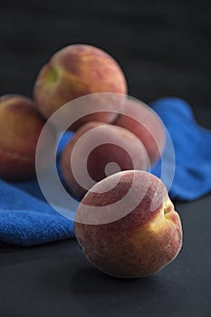 Peaches on a dark background. View from above. Space for text