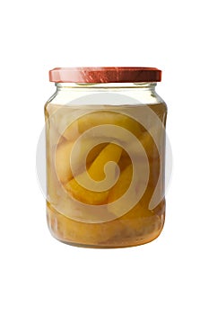 Peaches in a glass jar on a white background.