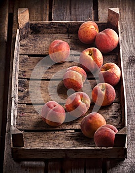 Peaches in old rustic wooden box