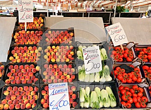 peaches ripe red tomatoes and fennel for sale at the greengrocer photo