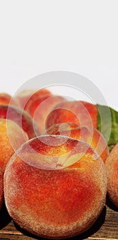 Peaches scattered on a wooden table, vertical image. Fruits on wooden background.