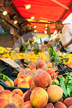 Peaches on stall with selling fruit on food market