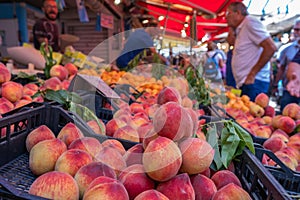 Peaches on stall with selling fruit on food market