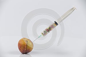 Peaches and syringe with pills