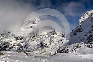 The peak in the clouds, a beautiful day after a winter storm at the Rila mountain in Bulgaria, Maliovica