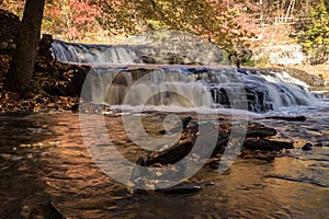 Peak fall foliage surrounds beautiful cascading middle Shohola Falls