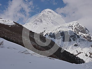 Peak of Mount Kazbek covered with snow in spring, Caucasus Mountains, Georgia