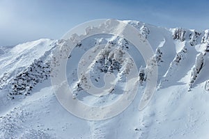 Peak of the Mountain. Beautiful landscape on the cold winter day. View of high mountains with snow white peaks.