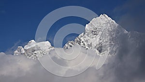 Peak of Mt Thamserku surrounded by clouds
