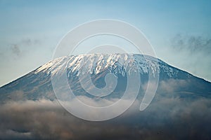 peak of the snow-covered Kilimanjaro volcano. Snow on top of Mount Kilimanjaro in Amboseli