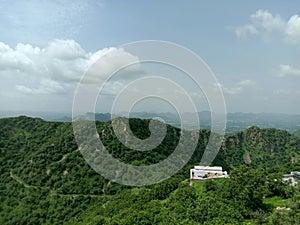 Peak view from sajjangarh palace  green aravali hils and sky in udaipur