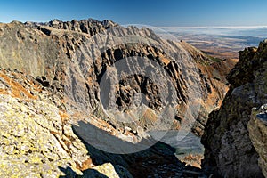 Peaks and frozen tarn in High Tatras mountains, Slovakia. View from peak Krivan