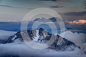 Peaks of Karavanke range and Kamnik-Savinja Alps rise above clouds photo