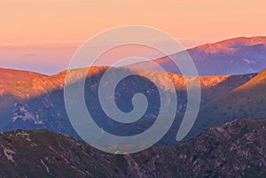 Peaks of Liptovske Kopy during sunrise from Hladky Stit mountain in High Tatras