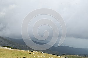 The peaks in mountain Pirin on background of dramatic sky storm clouds