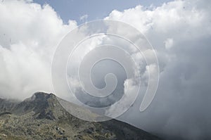 The peaks in mountain Pirin on background of dramatic sky storm clouds