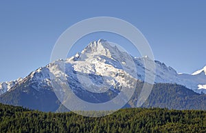 Peaks of the Tantalus Range at the southern end of the Coastal Mountains of British Columbia, Canada against blue sky
