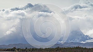 The peaks of the Torres del Paine mountains that emerge from the clouds, Torres del Paine National Park, Chile