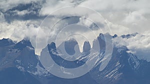 The peaks of the Torres del Paine mountains that emerge from the clouds, Torres del Paine National Park, Chile