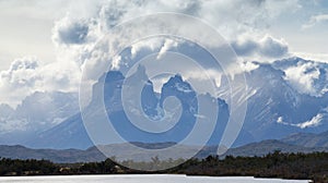 The peaks of the Torres del Paine mountains that emerge from the clouds, Torres del Paine National Park, Chile