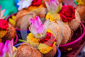 Pealed coconuts, lotus , rose and other flowers prepared for pooja, ritual worship in a temple