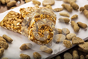 Peanut brittle or peanut chikki and roasted groundnuts photo