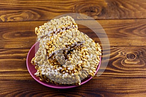 Peanut brittles in plate on wooden table