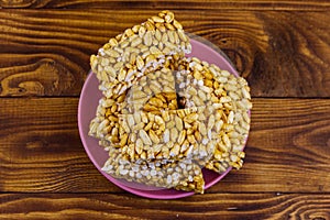 Peanut brittles in plate on wooden table