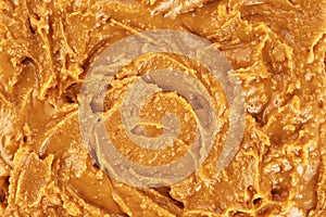 Peanut butter background, top view.