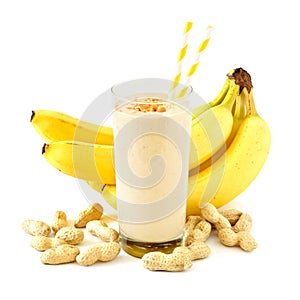 Peanut-butter banana smoothie with scattered ingredients over white