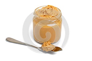 Peanut butter in a glass jar isolated on white background.