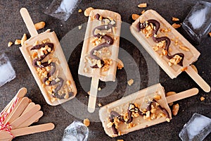 Peanut butter ice pops over a dark stone background