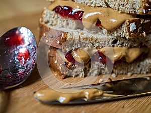 Peanut Butter and Jelly Sandwich on Cutting Board, Knife and Spoon