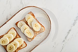 Peanut butter sandwich with fresh banana slices