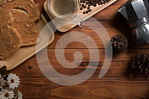 Peanut butter sandwich or toasts and coffee cup on wooden background.